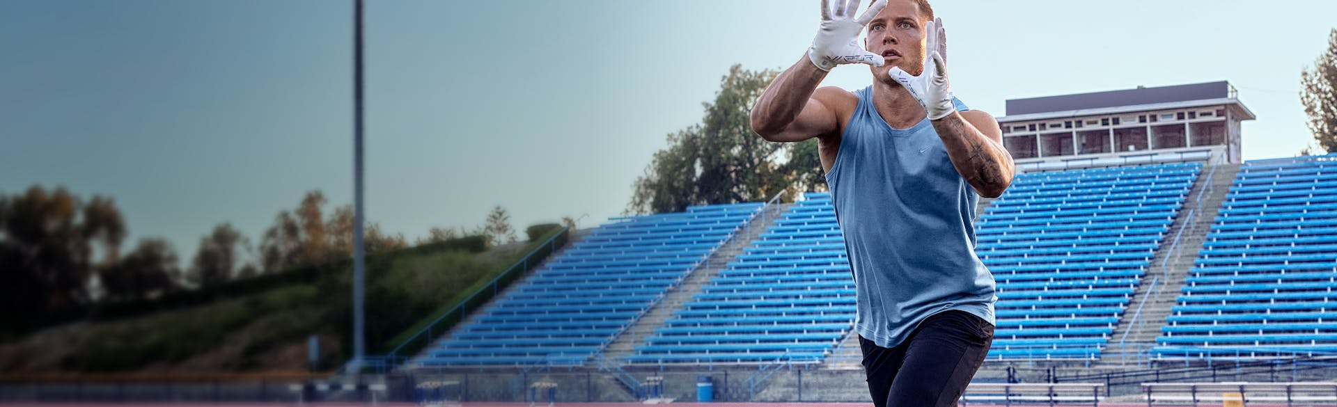 Christian McCaffrey catching a football on the practice field
